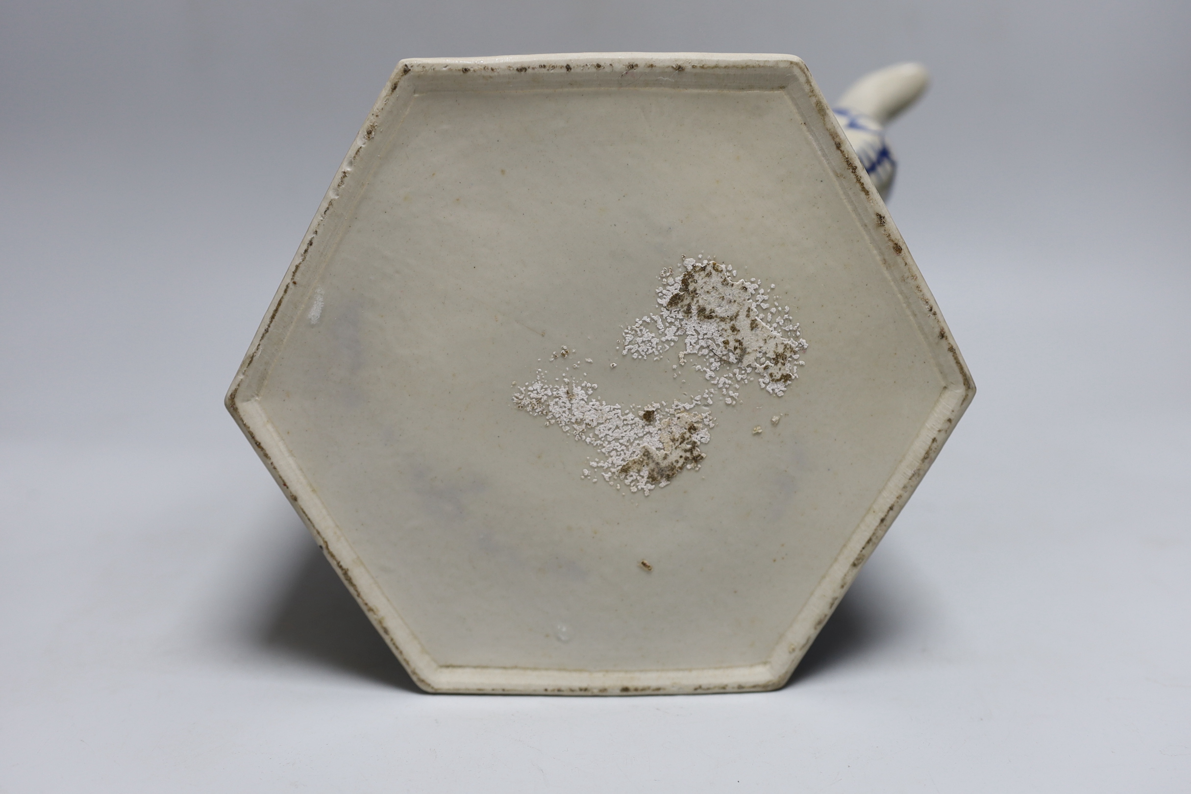 A Chinese blue and white oversized hexagonal teapot, with brass fitted handle and floral decoration, 30cm tall